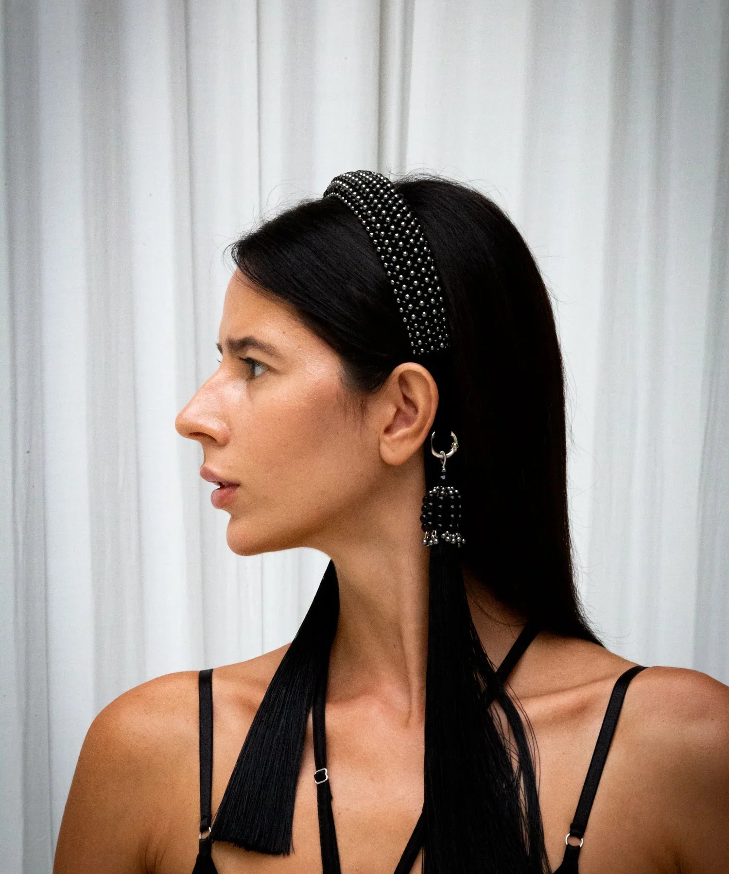 Woman wear black crystal and Polymer coated metal beads teuta headband jet black by Object & Dawn on neutral backgound