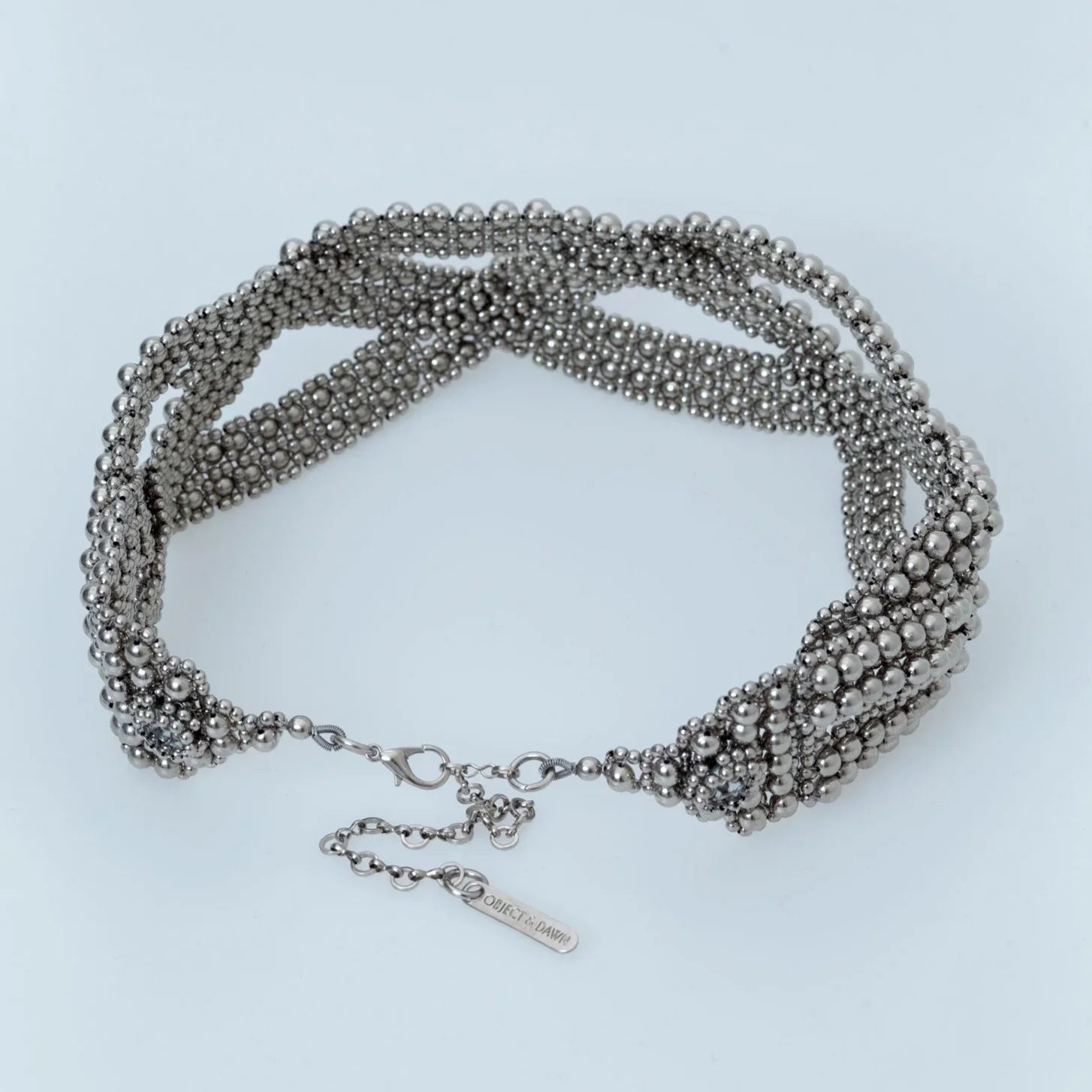 Beaded modular hat accessory from polymer metal beads by object and dawn on neutral background