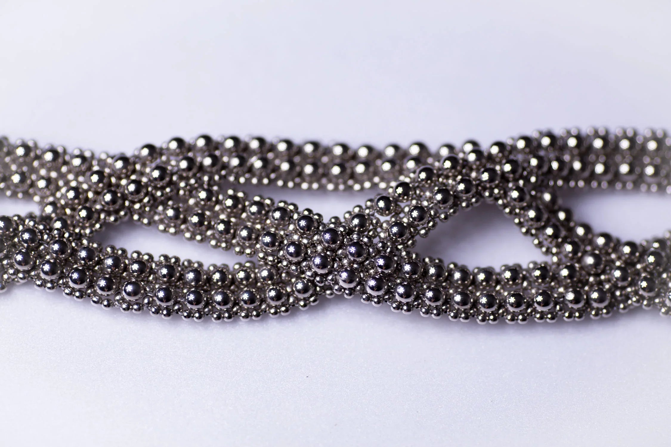detail beads of trinity modular hat from polymer metal beads on white background