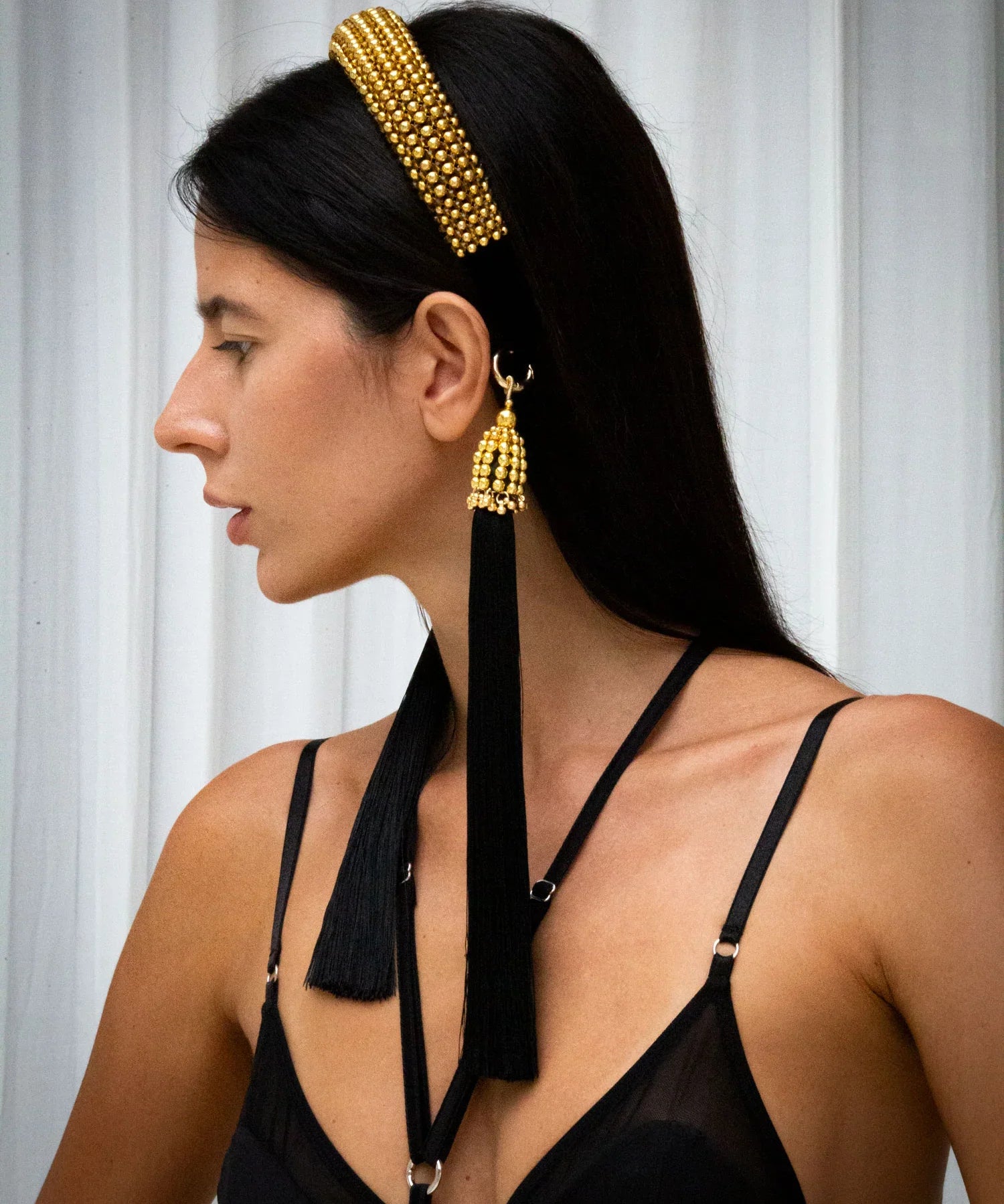 Woman in black outfit wear gold beaded Teuta Headband by Object & Dawn in netural background