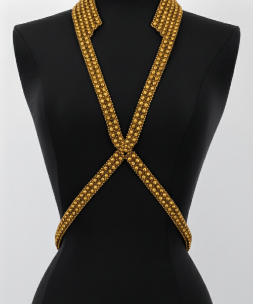 Black mannequin wearing a V-Necklace Harness gold by Object & Dawn  against a white background