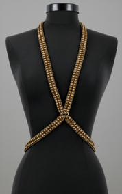 X-Shape Harness Necklace gold on a black mannequin against a gray background by Object & Dawn