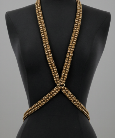 X-Shape Harness Necklace gold on a black mannequin against a gray background by Object & Dawn