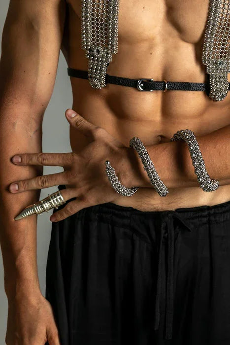 hand picture with handcrafted beaded modular spiral cuff on grey background by object and dawn