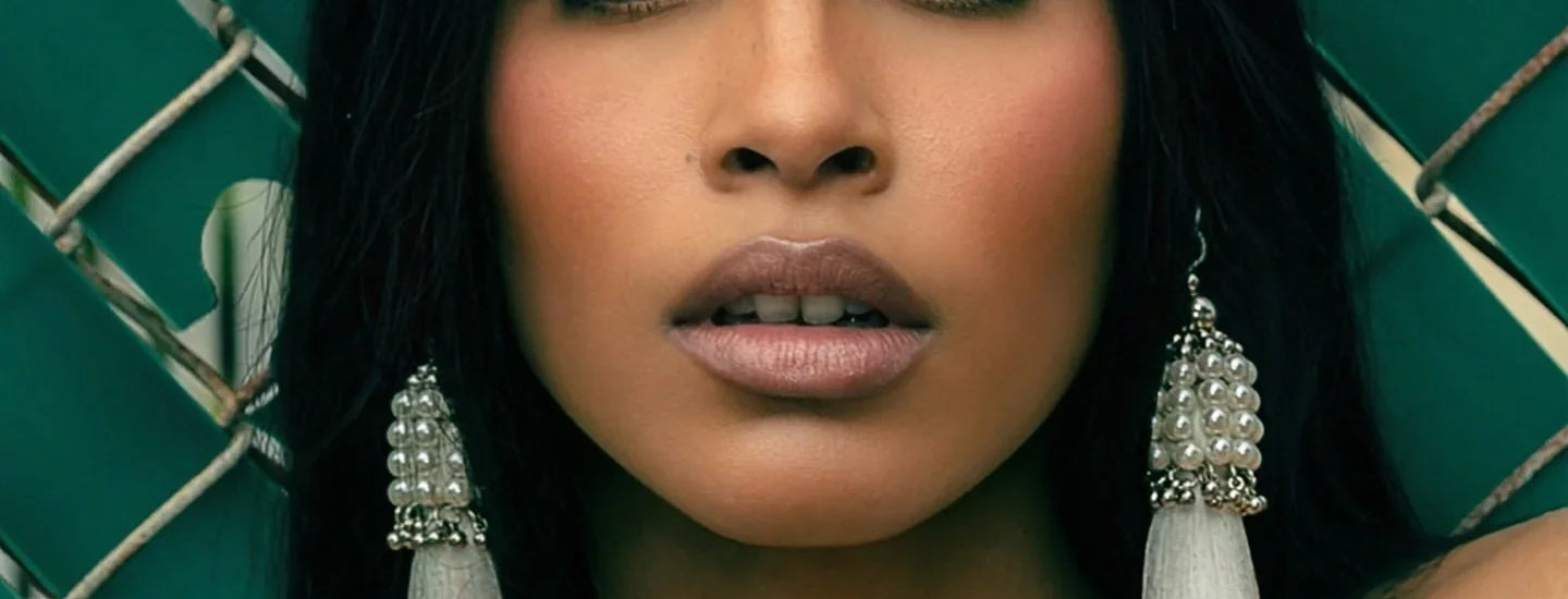 Woman wearing a decorative Khutulun Pearl headband by Object & Dawn against a dark green background