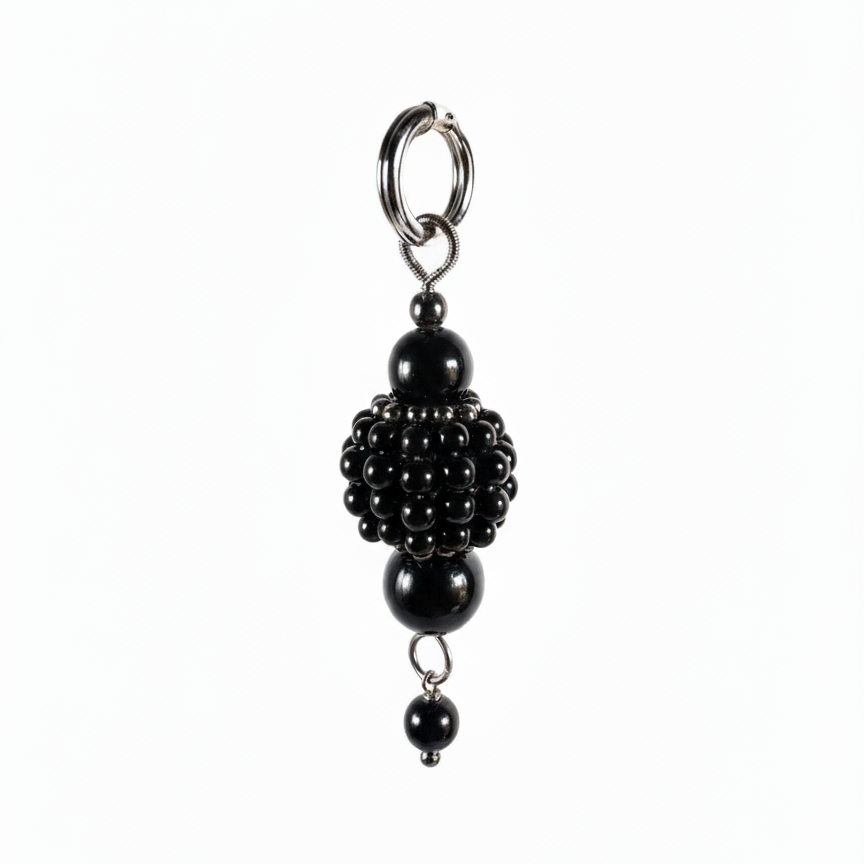 pearl medallion with black crystal and dark beads detailing close-up
