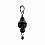 pearl medallion with black crystal and dark beads detailing close-up
