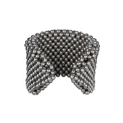 Object & Dawn handcrafted beaded wrist accessory in ivory, structured supple cuff with polymer metal beads, ghost image